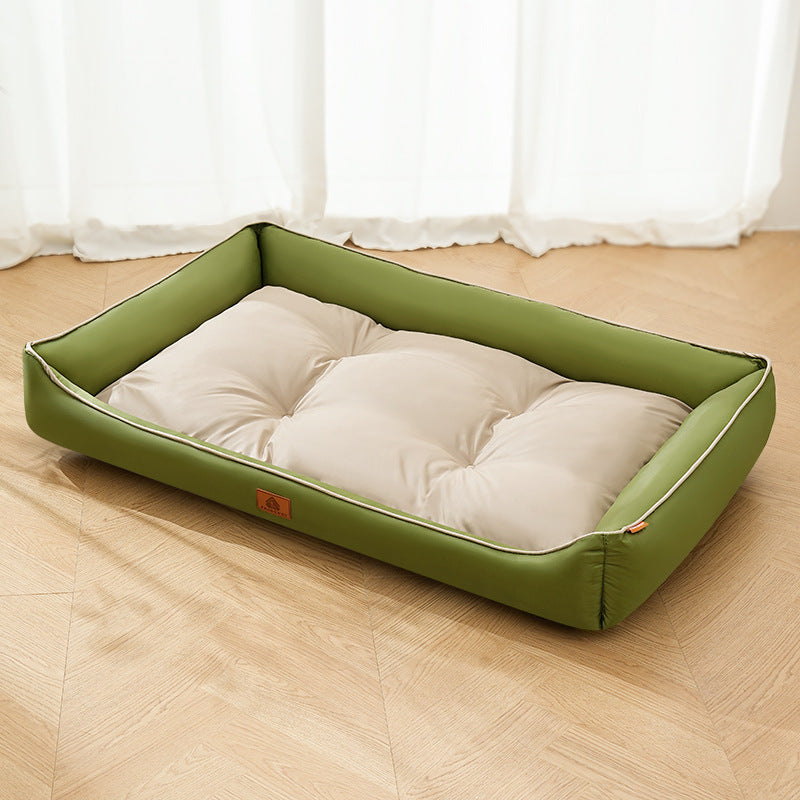 Nomi Nest dog bed with green sides and a cream cushion