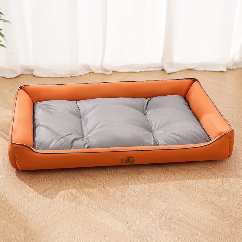 Orange dog bed with a gray cushion and raised sides