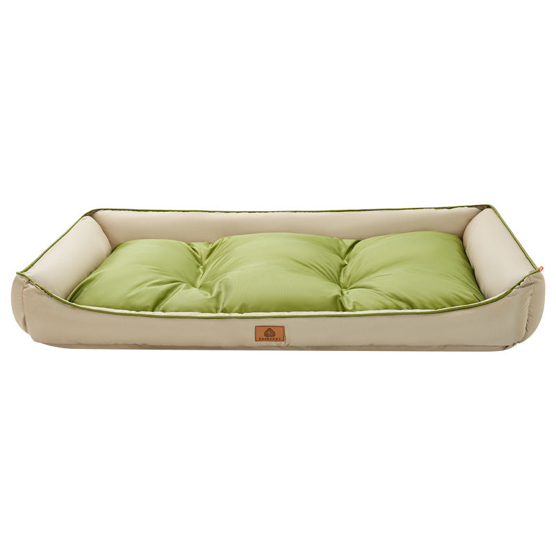 Green Nomi Nest dog bed with a cream cushion and raised sides